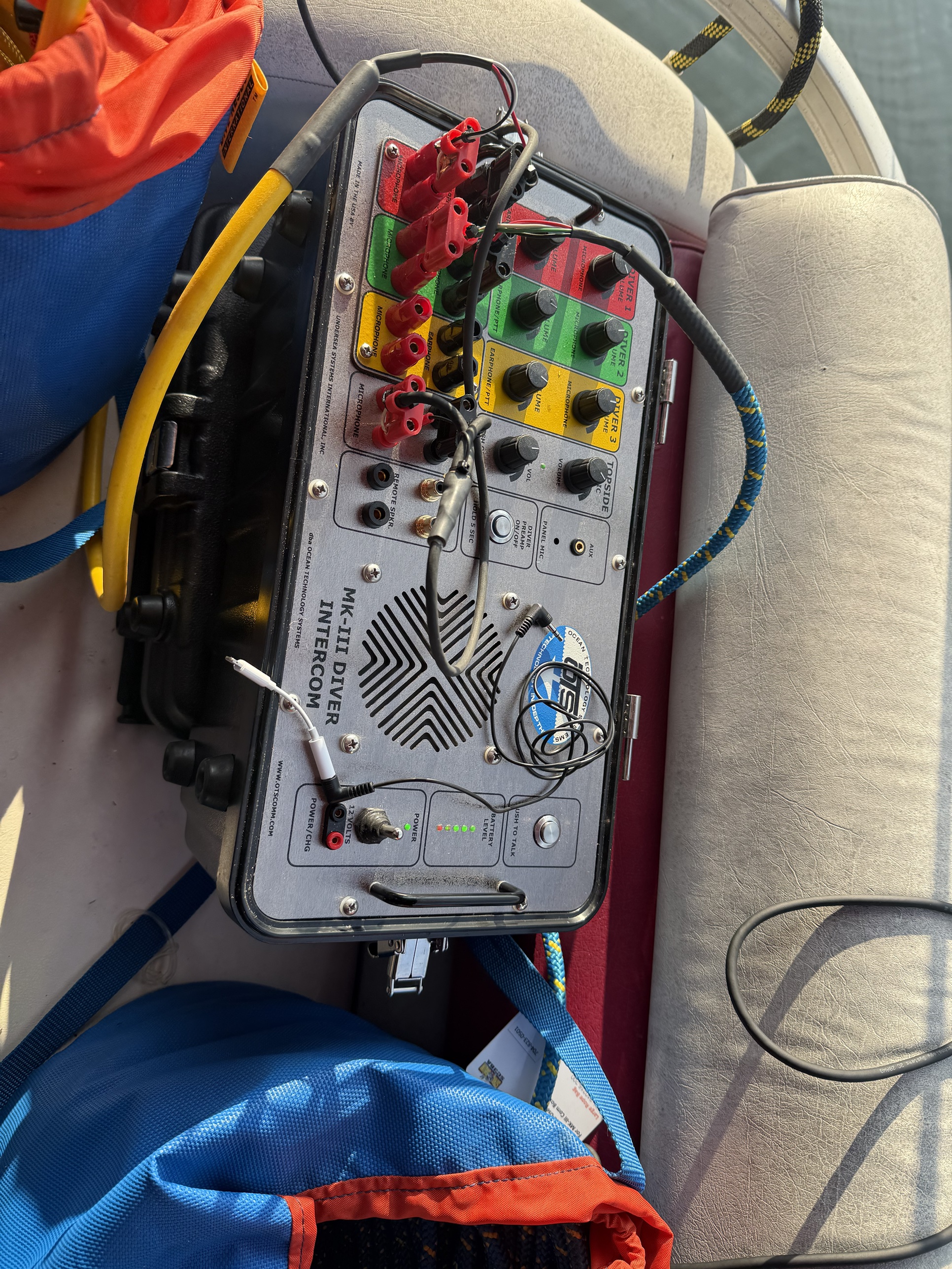 OTS MK-III three-diver hardwire intercom box on the boat seat at the Lake Adger Helene cleanup