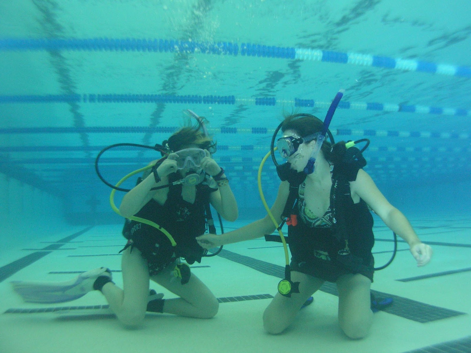 Scuba students practicing skills on the bottom of the pool during an open water class at Sink or Swim Scuba near Charlotte, NC