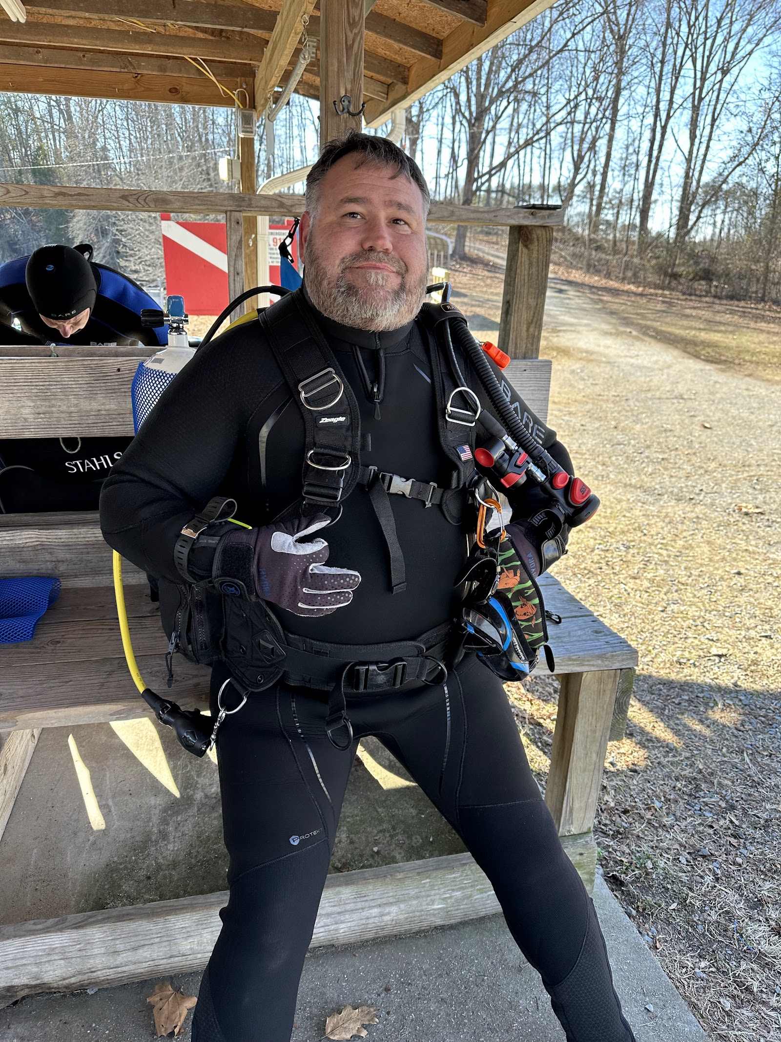 Scuba instructor at open water training dive Scuba instructor geared up in a wetsuit and BCD at an open water training site near Charlotte, NC