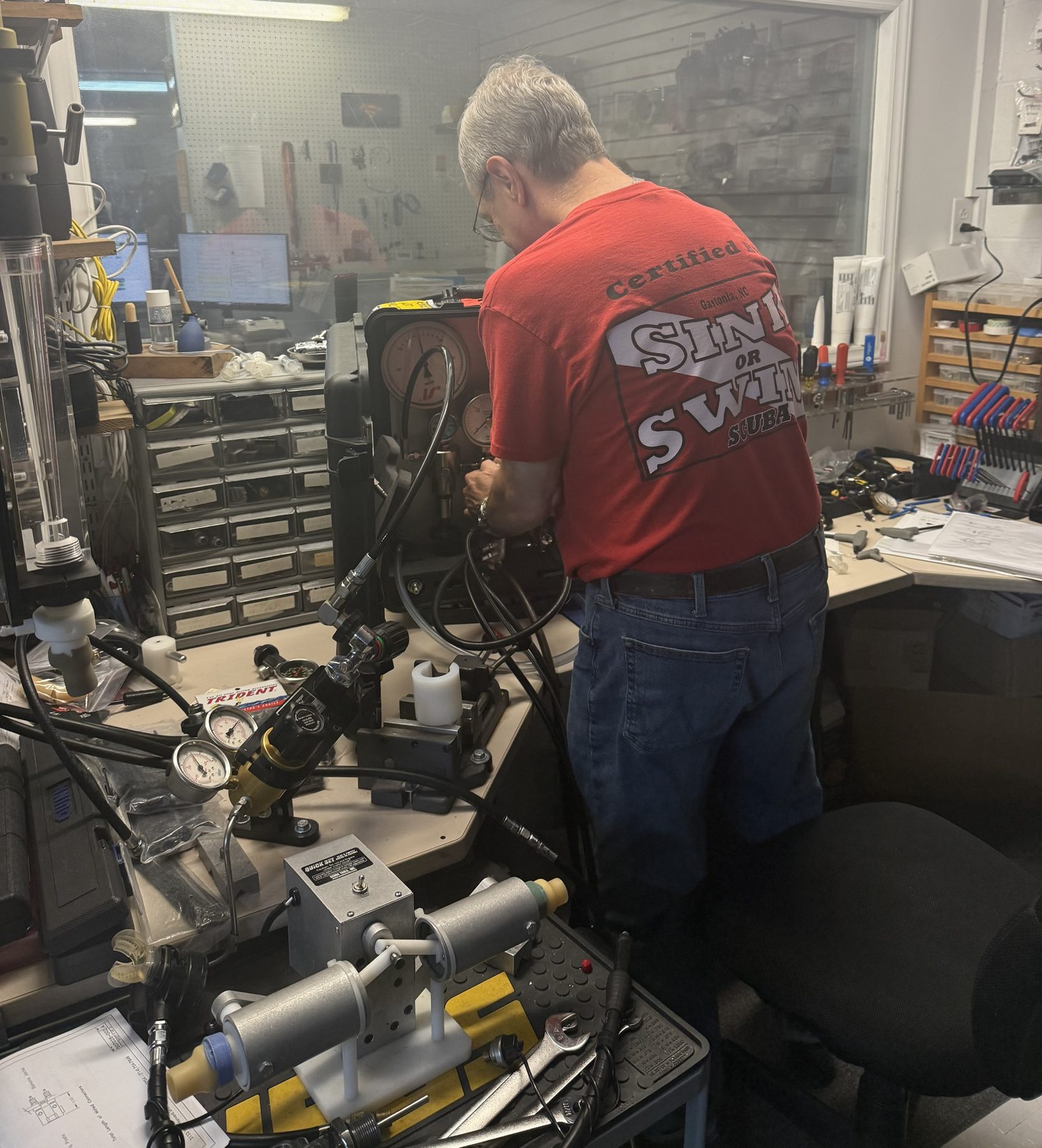 Sink or Swim Scuba technician at the regulator service workbench in Gastonia NC