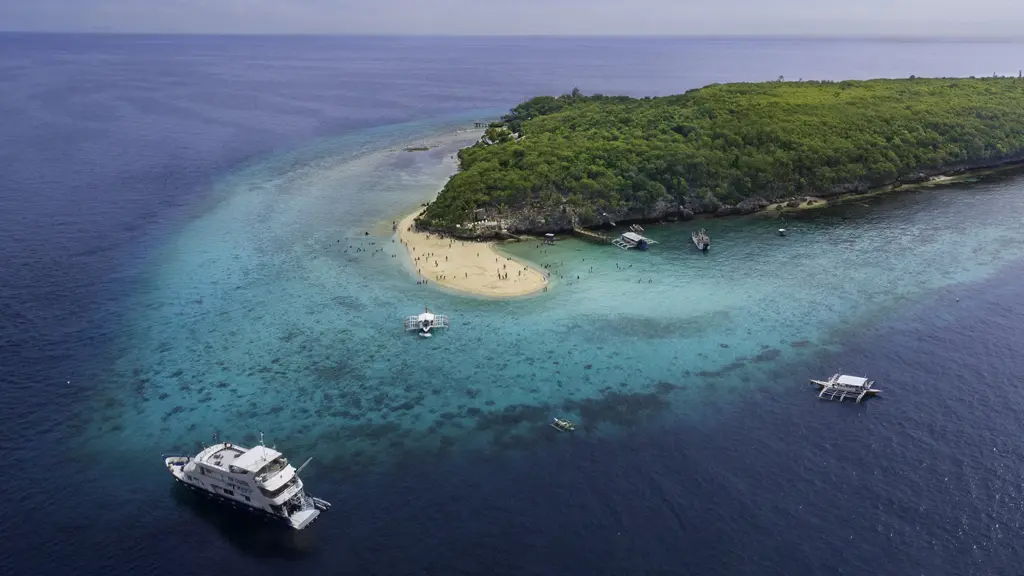 Atlantis Infiniti anchored beside a Philippine island
